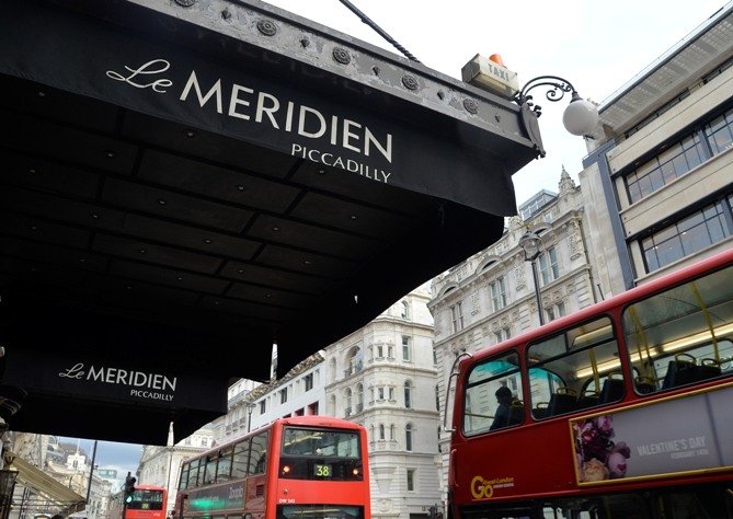 London buses pass 'Le Meridien Piccadilly' hotel, owned by Starwood Hotels, in Leicester Square in central London.