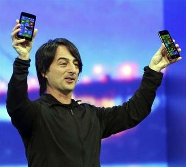 oe Belfiore, vice president of the operating system group at Microsoft, holds a pair of mobile phones featuring the new Windows 8.1 operating system.
