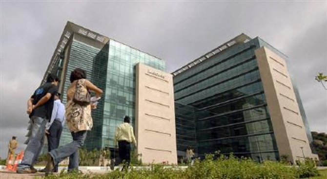 Employees walk near Microsoft India Development Center in Hyderabad