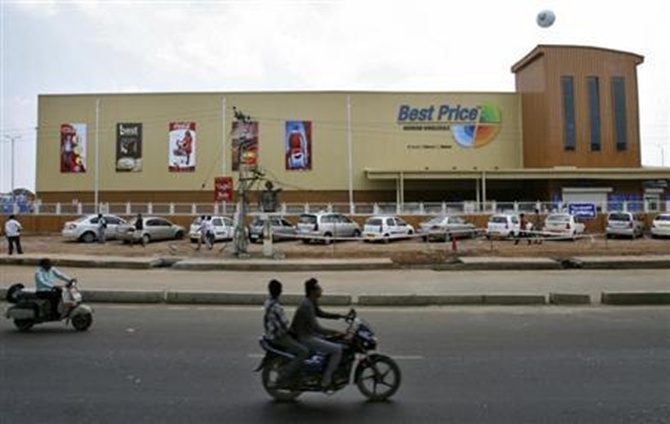 Two-wheelers move past the newly opened Bharti Wal-Mart Best Price Modern wholesale store in Hyderabad.