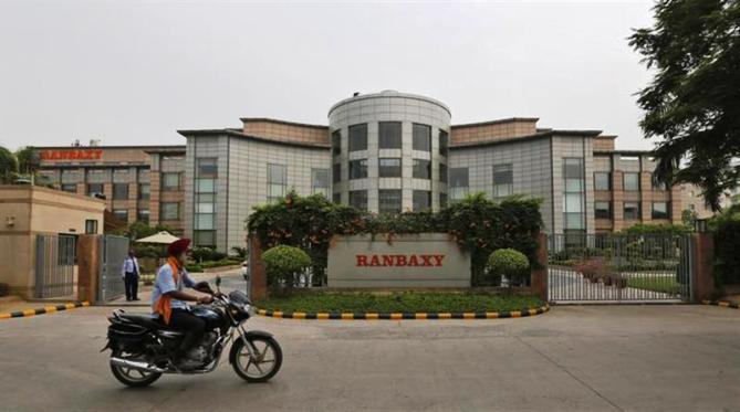 A man rides a motorcycle in front of the office of Ranbaxy Laboratories at Gurgaon, on the outskirts of New Delhi.