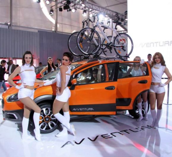 Models display Fiat Punto Avventura at the Indian Auto Expo.