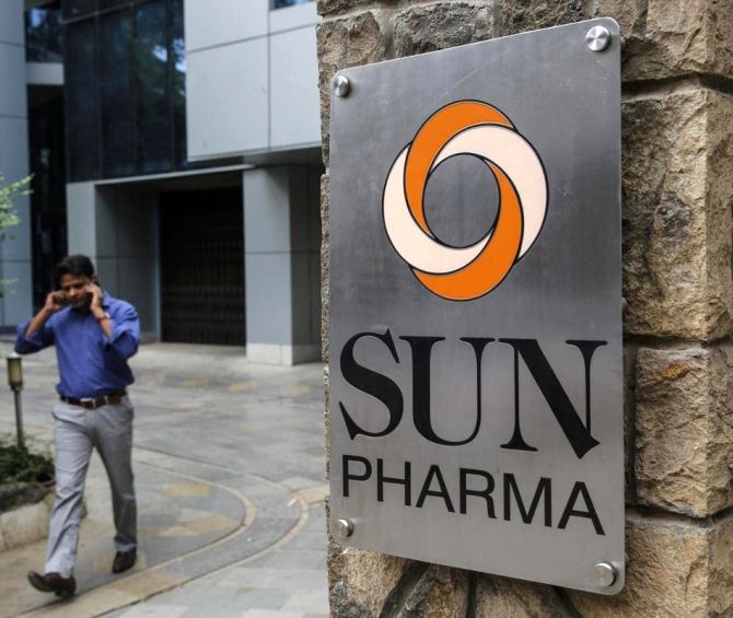 An employee speaks on phone as he walks out of research and development centre of Sun Pharmaceutical Industries.