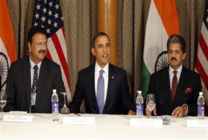 US President Barack Obama sits next to Ajay Piramal (L) and Anand Mahindra during a meeting with entrepreneurs in Mumbai.