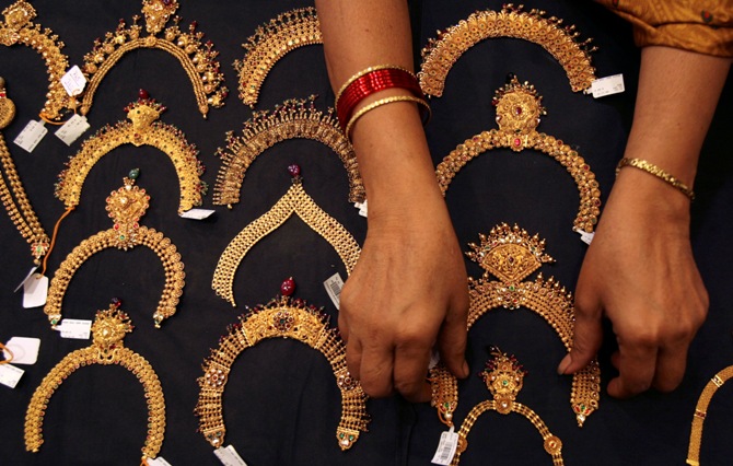 A woman checks a gold necklace inside a jewellery showroom in Hyderabad.