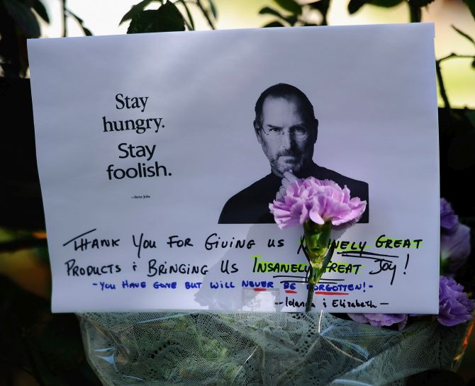A make shift memorial for Steve Jobs is seen on the sidewalk outside his home.