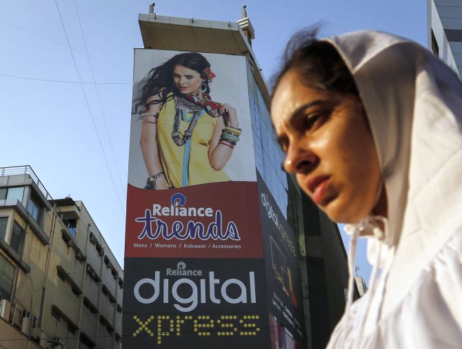 A woman walks past a Reliance Trends mall at a shopping district in Mumbai.