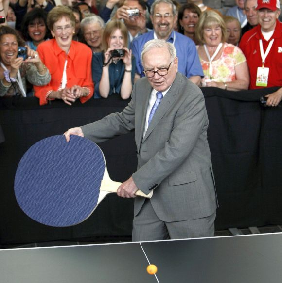 Berkshire Hathaway chairman Warren Buffett plays table tennis with a world champion using a giant paddle at the Berkshire Hathaway annual meeting weekend in Omaha.