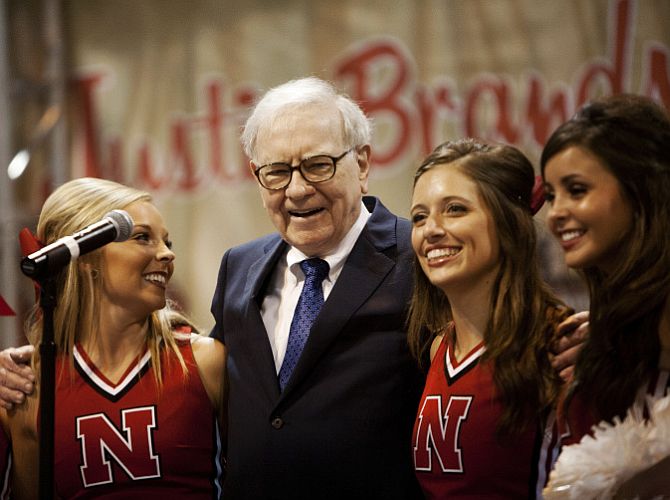 Warren Buffett sings with University of Nebraska cheerleaders during the Berkshire Hathaway Annual shareholders meeting in Omaha.