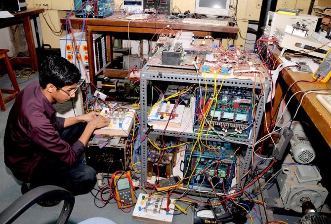 A student assembles his project at the 2014 Open House at the IIT Delhi.