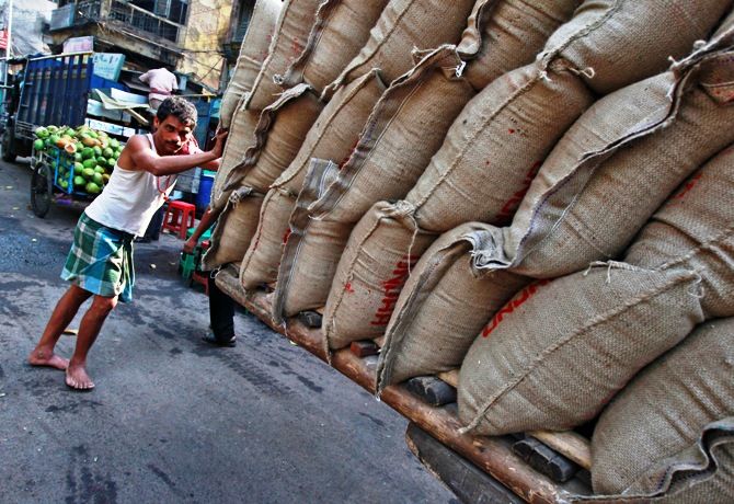 Image: A labourer pushes a hand cart loaded with sacks of rice at a wholesale market in Kolkata. Photograph: Rupak De Chowdhuri/Reuters
