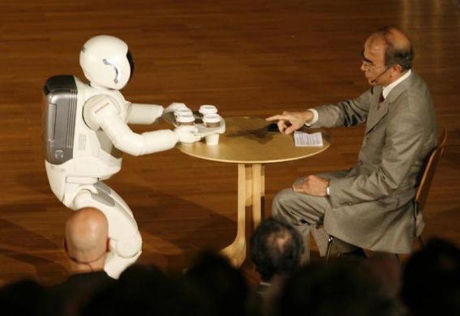 Asimo serves some drinks during a presentation at the university of Bielefeld during its first appearance in Germany.