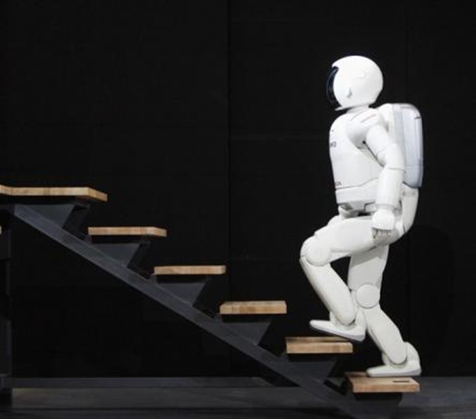 Honda's second version of the humanoid robot Asimo climbs a flight of stairs in Barcelona.