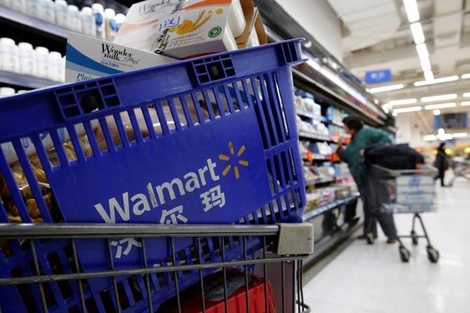 A shopping cart full of products is seen as a customer shops at a Wal-Mart store.