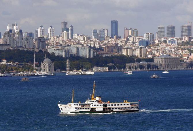 A ferryboat moves along the Bosphorus and past the city's skyscrapers (rear) in Istanbul.