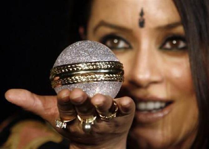 Actress Mahima Chaudhary holding a diamond studded ball.