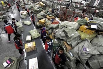 Workers sort packages at a logistics hub in Jinan, Shandong province, China. Photograph: Reuters