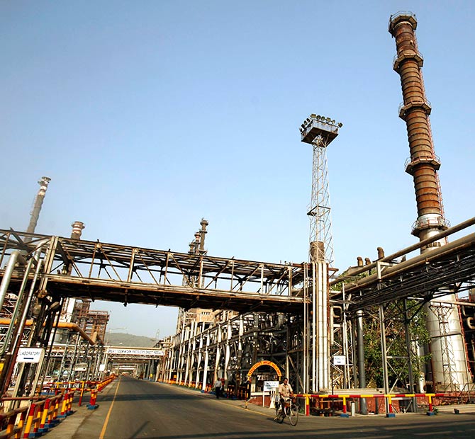 A worker rides a bicycle at the Bharat Petroleum Corporation Ltd. refinery in Mumbai.