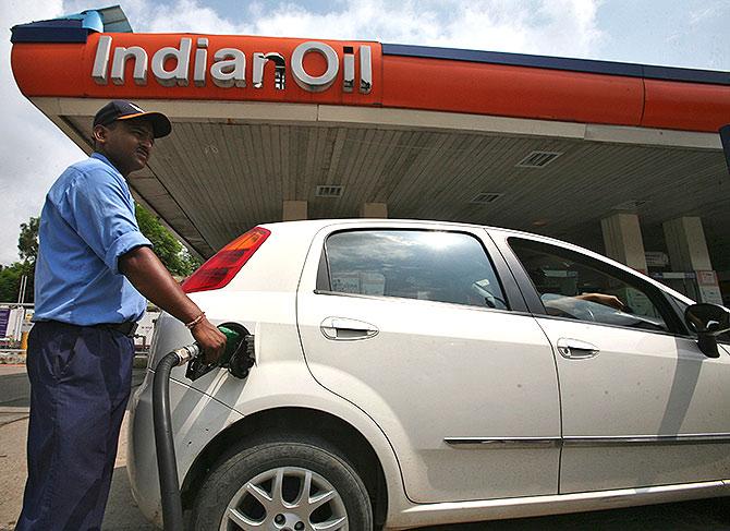 A worker fills a car with diesel at a fuel station in Jammu.