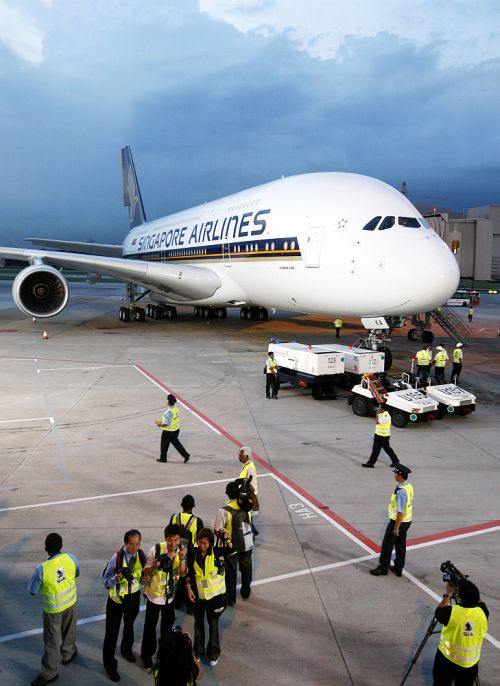 People have their photo taken in front of the Airbus A380 superjumbo at Singapore's Changi Airport.
