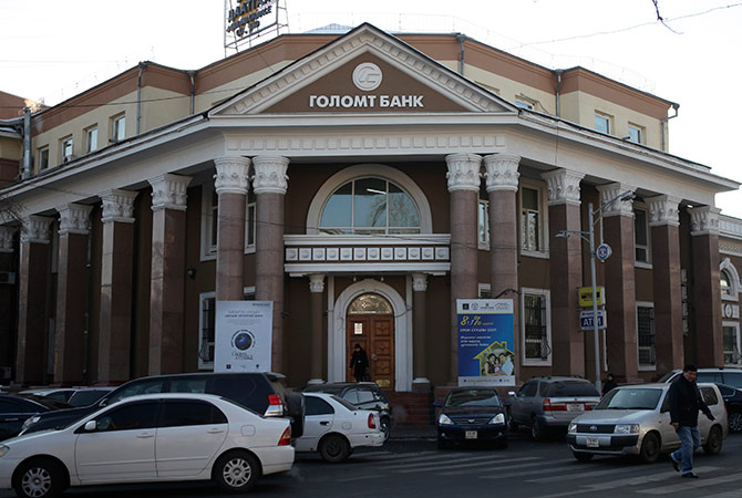 Cars drive past a branch of Golomt Bank in Ulan Bator.