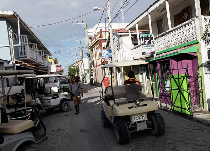 A man rides a buggy in the main square in San Pedro.