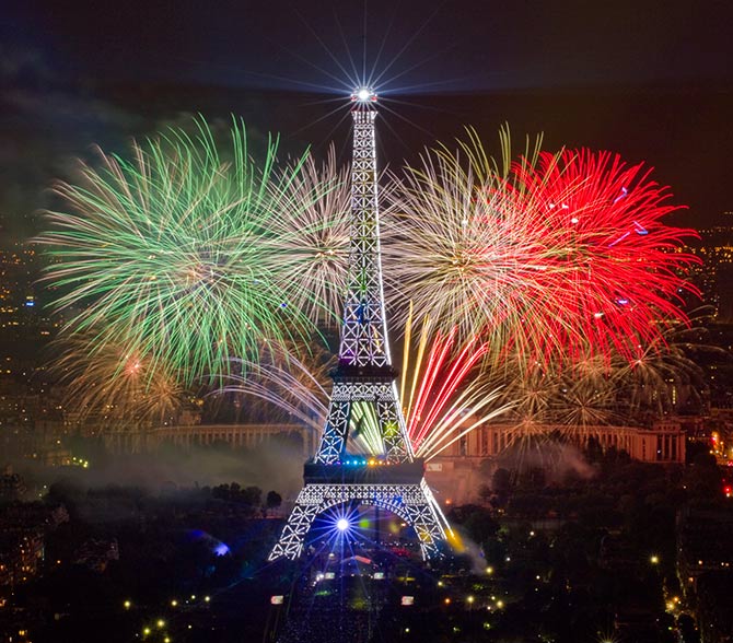 The Eiffel Tower is illuminated during the traditional Bastille Day fireworks display in Paris.