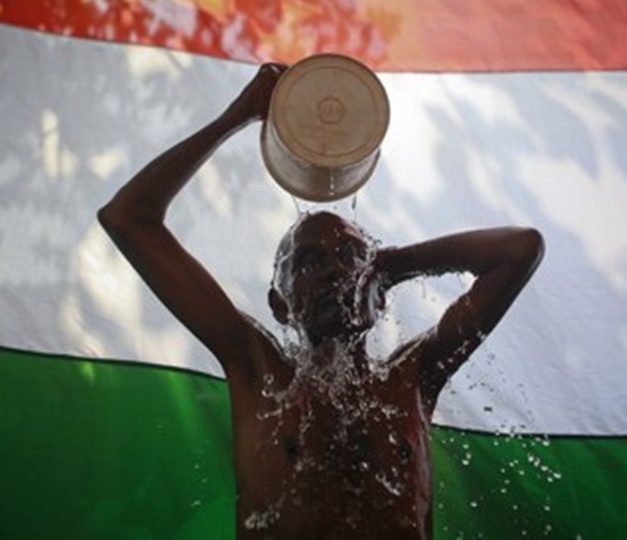 A man takes a bath outside his shanty in Dharavi, Mumbai.