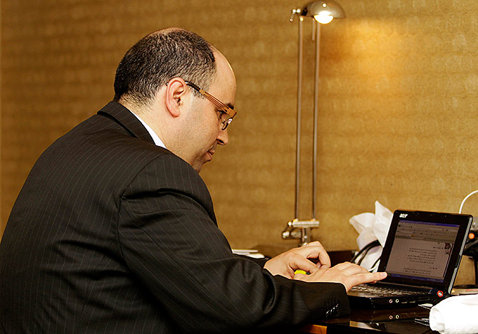 An executive checks his laptop during.