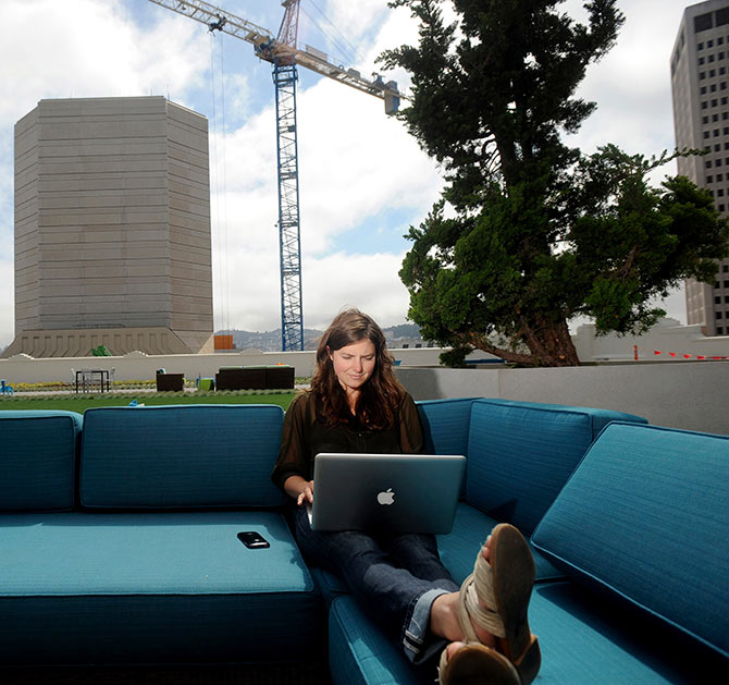 Jenna Sampson, a community relations manager at Twitter, works on the company's rooftop deck.
