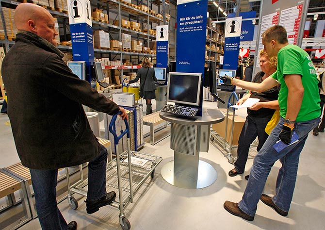 Customers check products on computer terminals at IKEA's newest store.