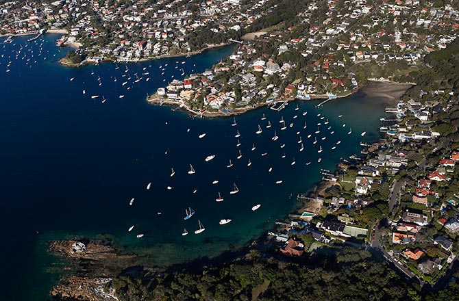 Boats are docked at Vaucluse bay (R) on a sunny winter afternoon in Sydney.