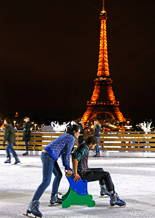 People ice skate on an artificial rink built for the Christmas holiday season across from the Eiffel Tower in Paris.