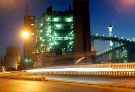 Traffic moves on a street in front of a thermal power in Ahmedabad.