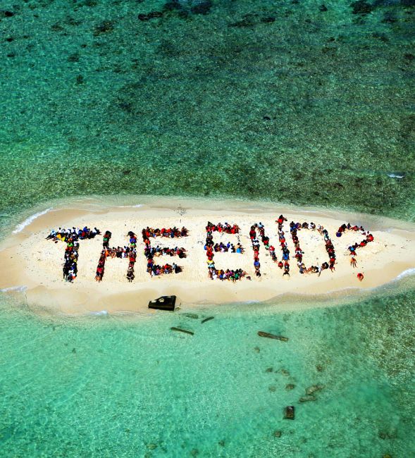Hundreds of Belizians and international supporters gather on an island to form a message on the Barrier Reef off the coast of Belize City.