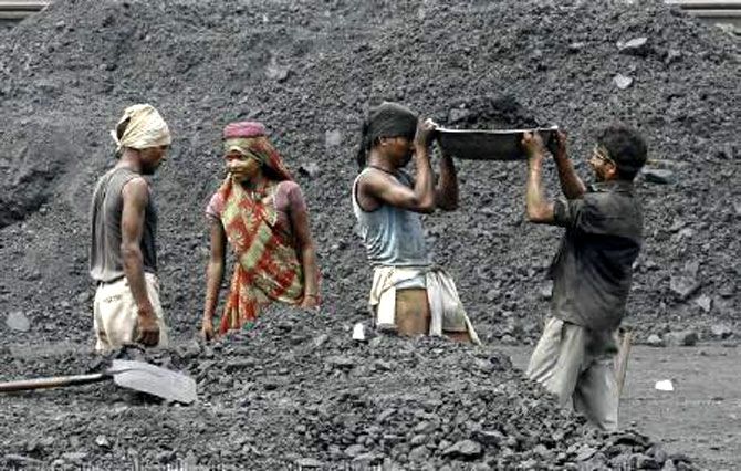 Laborers work in a railway coal yard on the outskirts of Ahmedabad. Photograph: Amit Dave/Reuters