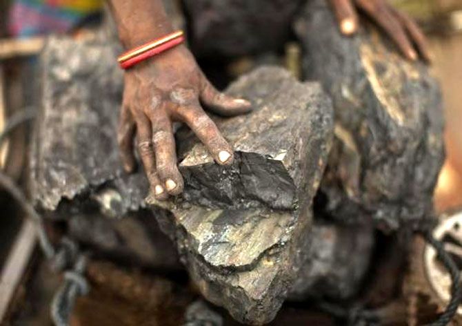 A local woman prepares to carry coal at an open coal field at Dhanbad, Jharkhand. Photograph: Ahmad Masood/Reuters