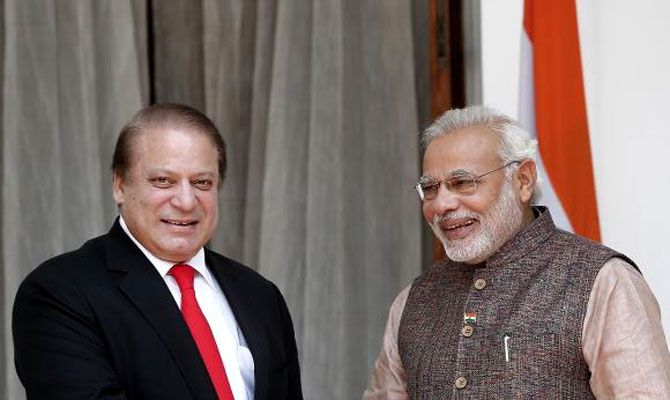 Prime Minister Narendra Modi (R) and his Pakistani counterpart Nawaz Sharif smile before the start of their bilateral meeting in New Delhi May 27, 2014. Photograph: Adnan Abidi/Reuters