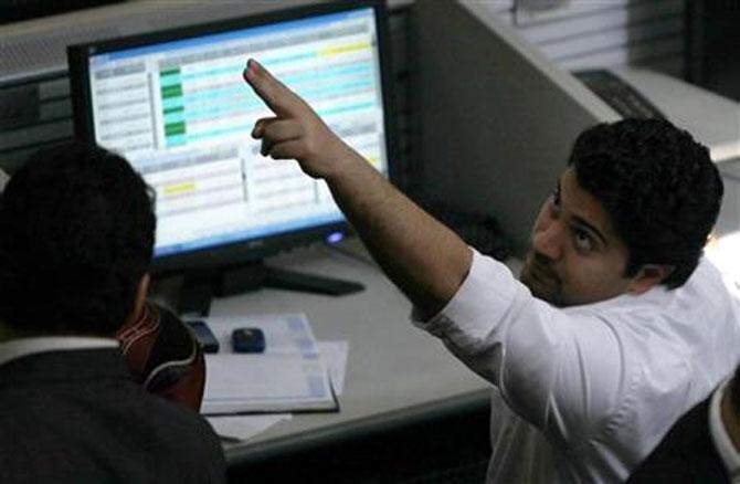 Traders work at a stock exchange.