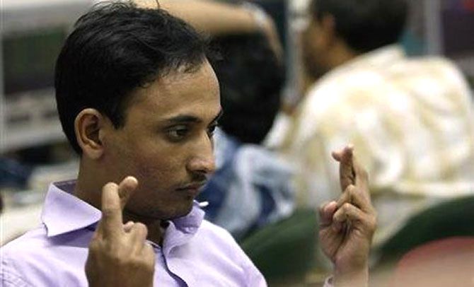 A market trader reacts to movement of the Sensex.