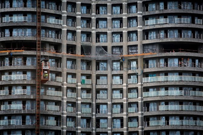 Labourers work at a construction site of a high-rise residential building in central Mumbai