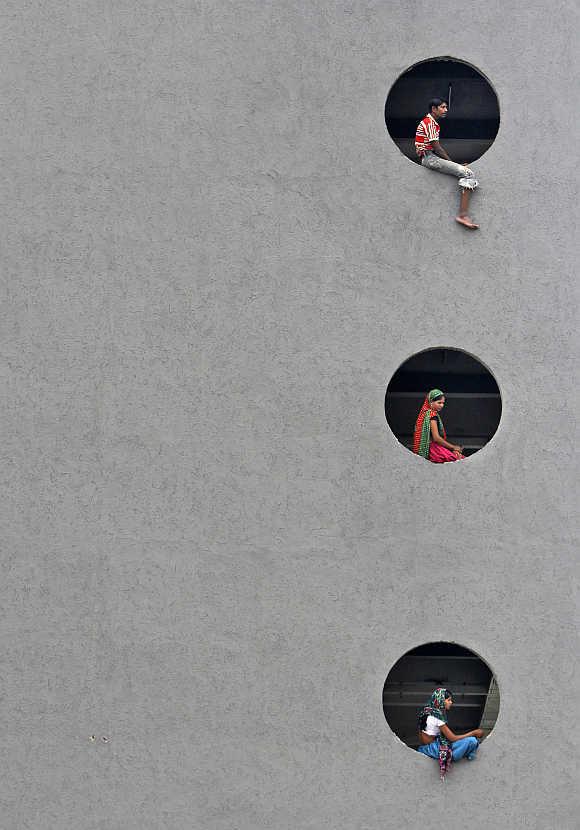 Labourers rest inside a newly constructed commercial building in Ahmedabad.