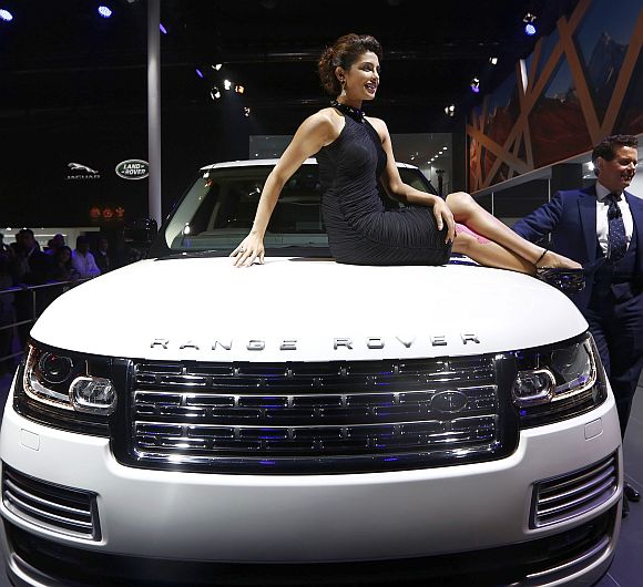 Bollywood actress Priyanka Chopra poses with Jaguar Land Rover's Range Rover LWB during its launch.