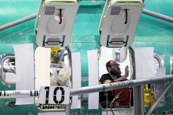 An employee is pictured while working during a tour of the Boeing 737 assembly plant in Renton.