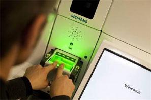 A man demonstrates the issuing of biometric passport. Photograph: MIRO KUZMANOVIC/