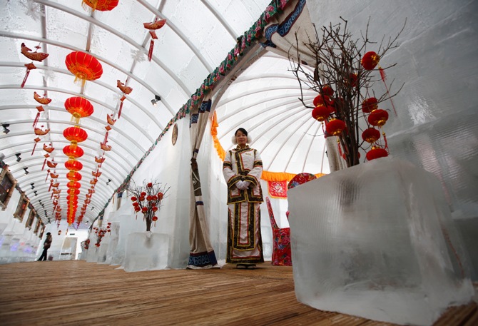 A waitress poses during a photo opportunity at the Ice Palace in Shangri-La Hotel in the northern city of Harbin, Heilongjiang province.