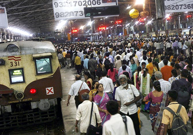 People walk on platforms of Chhatrapati Shivaji Terminus railway station in Mumbai.