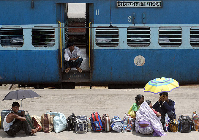 Passengers queue up on the platform of the Howrah station.