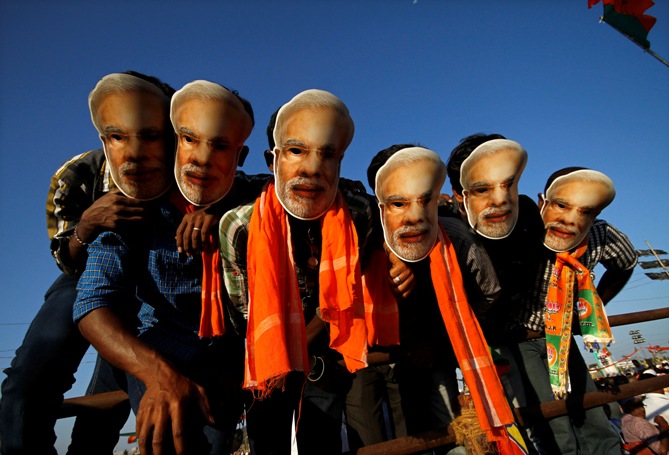 Supporters of Gujarat's chief minister Narendra Modi wear masks of Modi during a rally in Chennai.