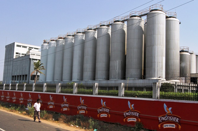 A man walks outside the factory of United Breweries Ltd (UB) that manufactures Kingfisher beer in Thiruvalluar district of Tamil Nadu.